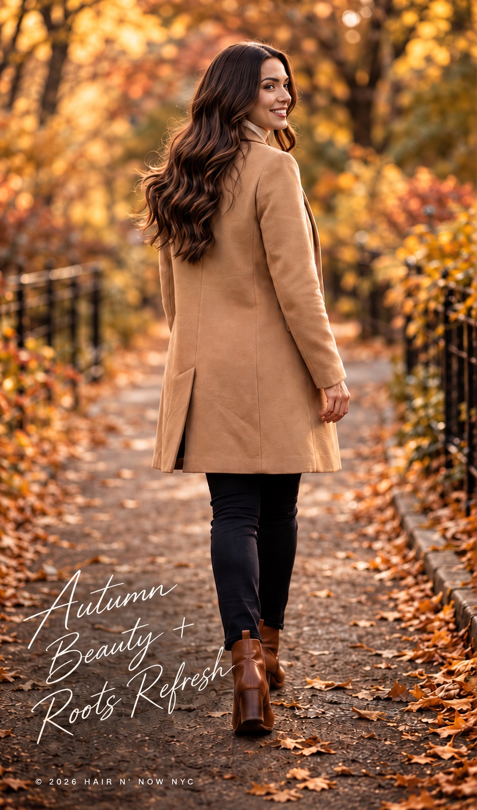 Woman with long, softly waved brunette hair in a camel coat walking through a golden autumn park.